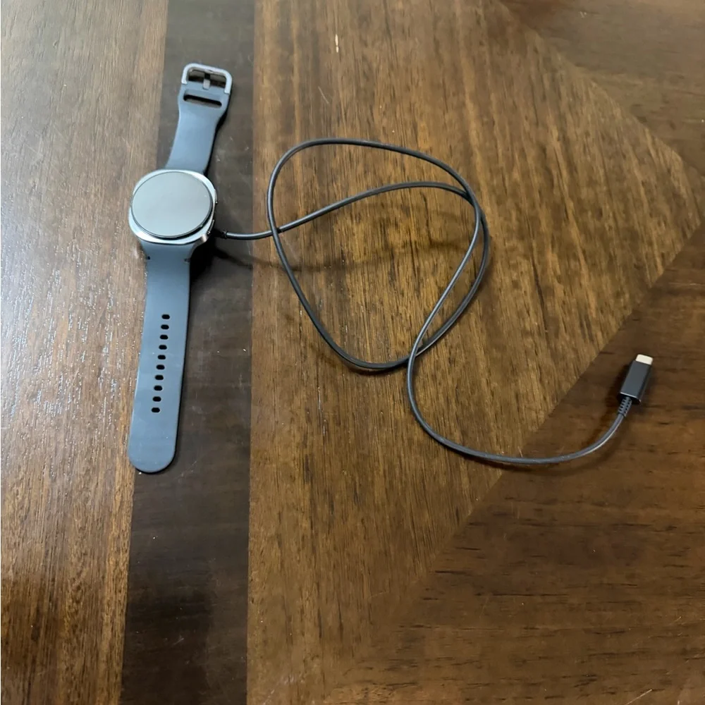 Samsung Smartwatch with Gray Band and Charging Cable